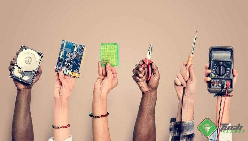 Hands holding Hard Disk and other electronics tools